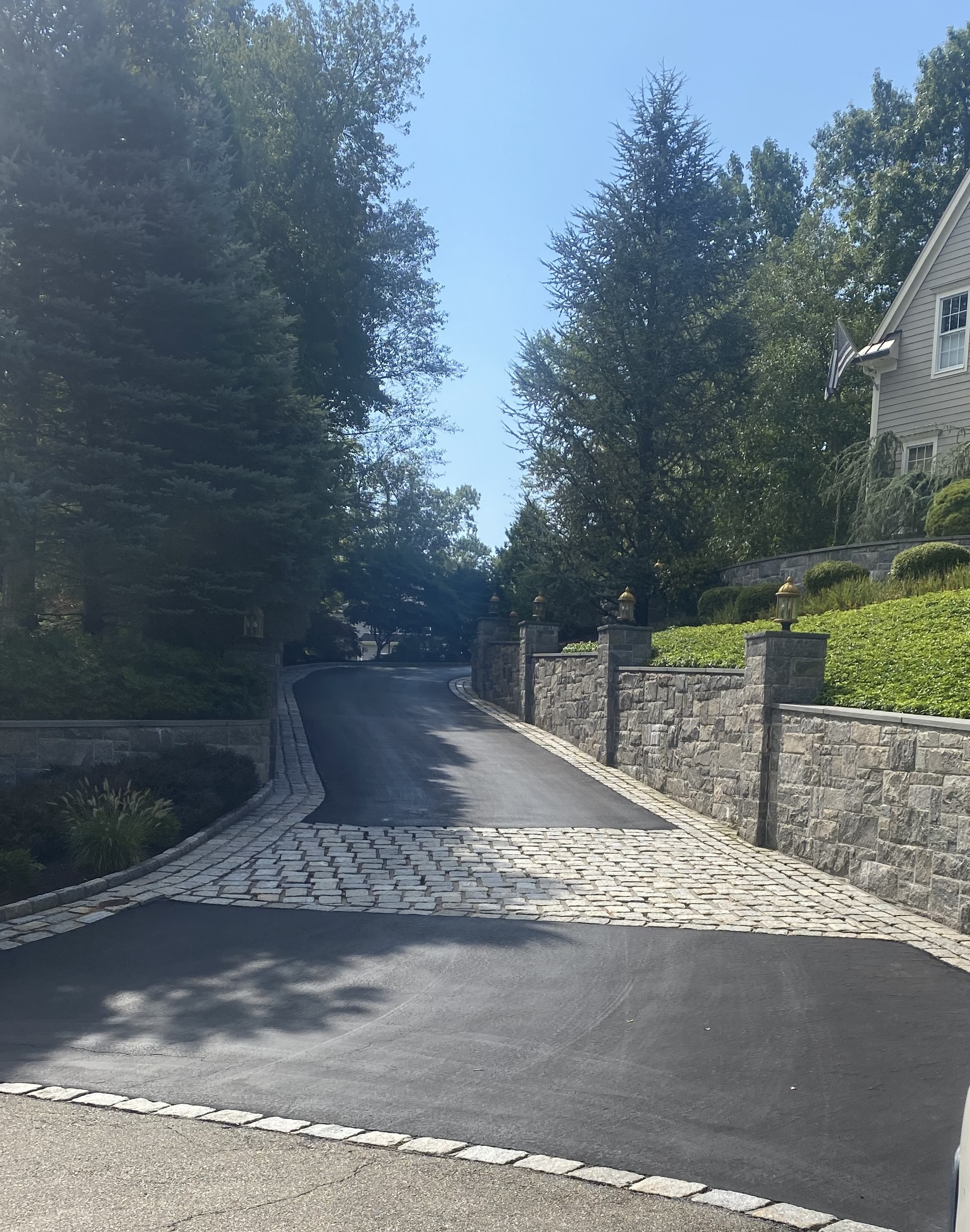 Custom masonry driveway and stone wall project by V.E.W Contracting